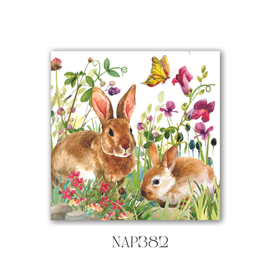 Pack of 20 Bunny Meadow Cocktail Napkins with a charming bunny and floral design. These soft, triple-ply paper napkins add elegance to special occasions or everyday gatherings. Pack size: 6, folded dimensions: 12.5 x 12.5 cm