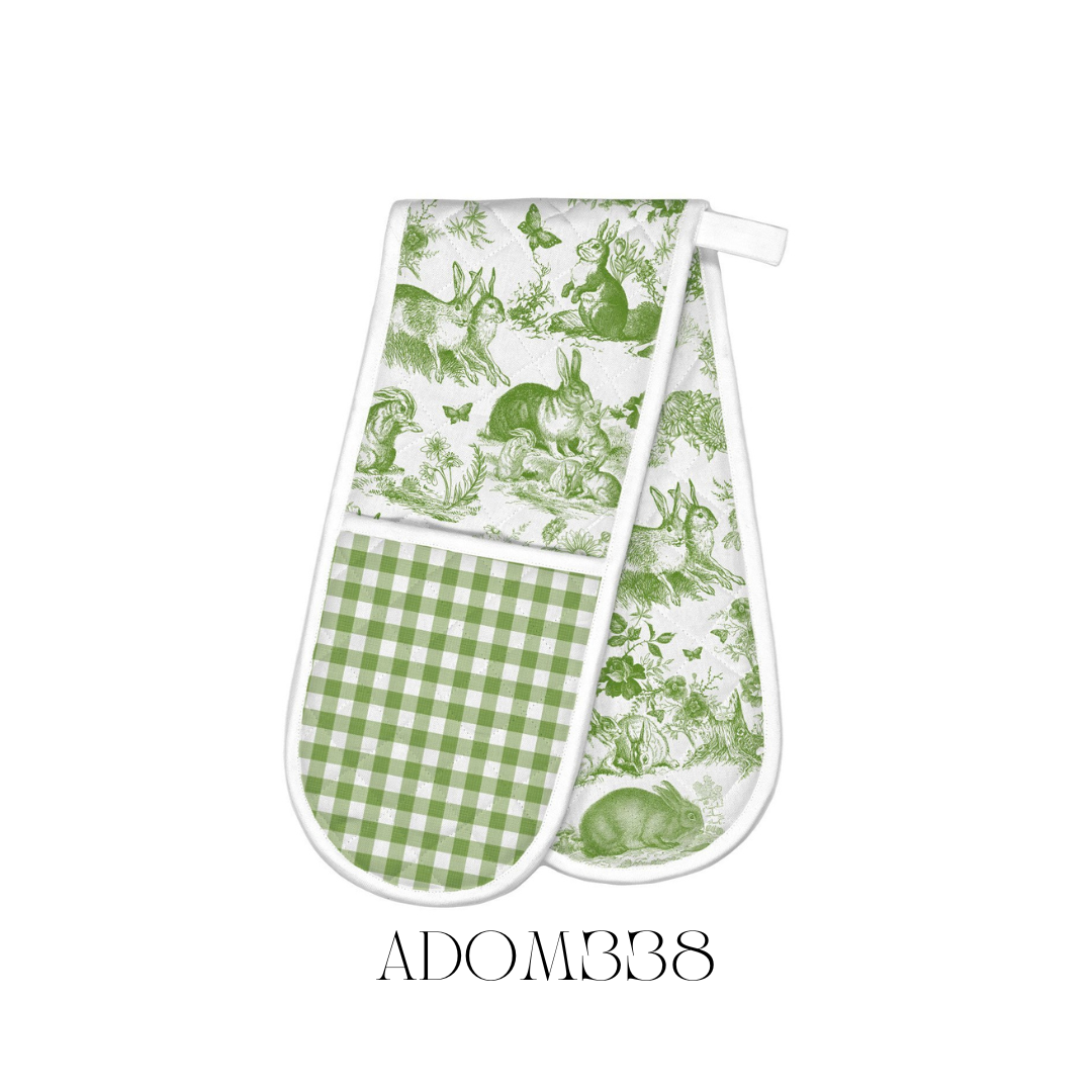 Bunny Toile Double Oven Mitt laid out flat, showcasing its elegant toile design featuring bunnies. Made from 100% cotton with a cotton/poly fill for extra thickness, providing protection from hot dishes. Size approximately 85 x 27.75 cm