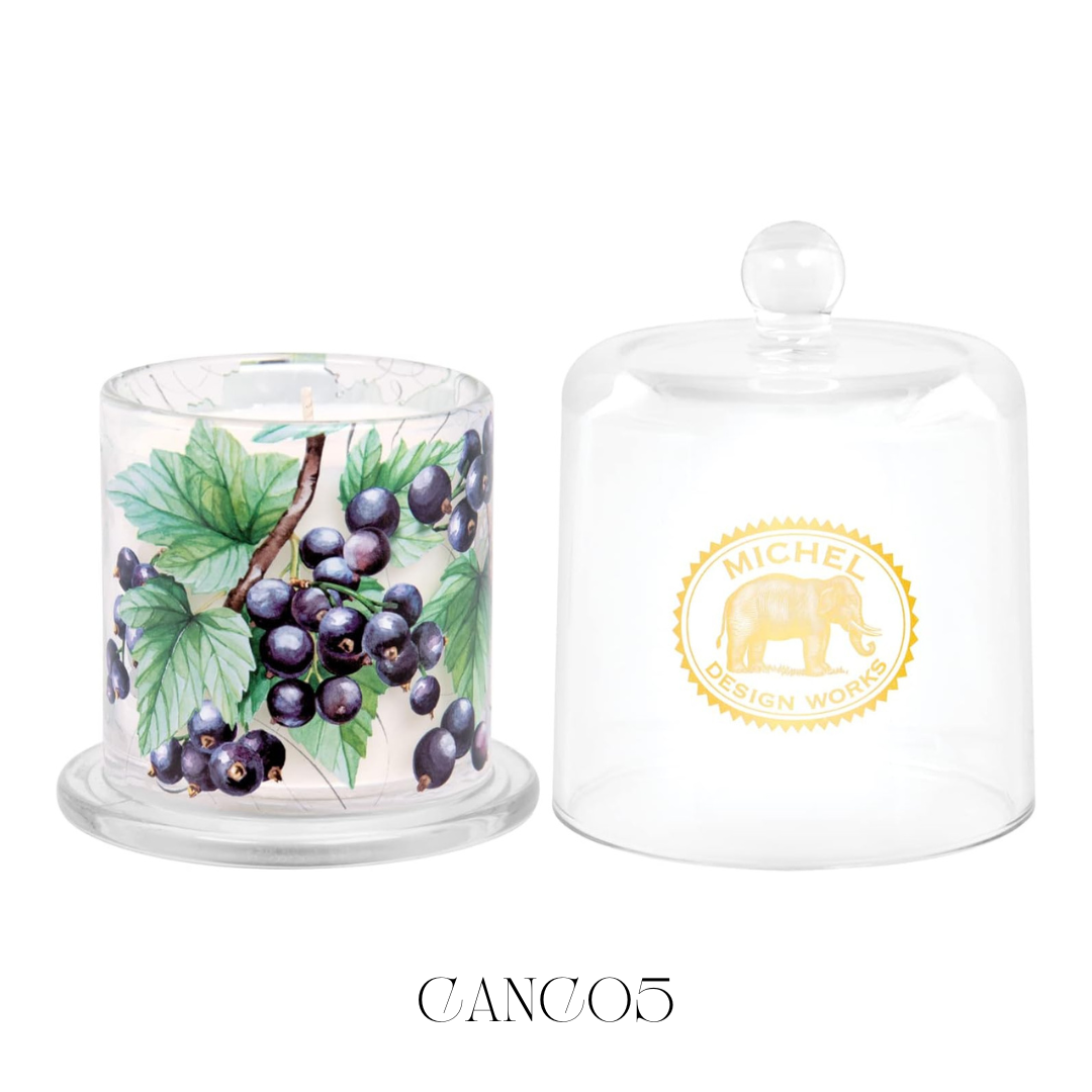 Cloche Candle Cassis, featuring a bell-shaped glass cloche that elegantly covers the soy blend candle. Lifting the cloche releases the deep, rich aroma of cassis, enhancing the ambiance of any room with its strong fragrance throw