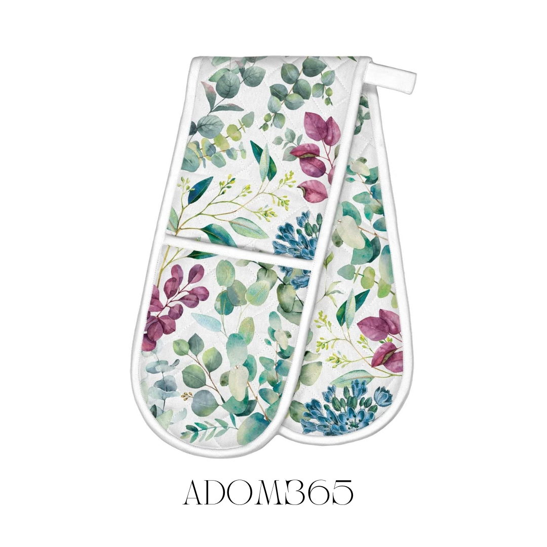 Eucalyptus and Mint Double Oven Mitt displayed flat, crafted from 100% cotton with a cotton/poly fill for extra thickness. The mitt measures approximately 85 x 27.75 cm, adorned with a refreshing eucalyptus and mint design, providing effective protection from hot kitchen dishes