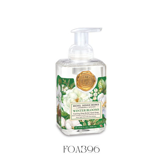 Foaming Soap Winter Blooms in a beautifully designed bottle, featuring bright blooms and lush greenery for a lively winter scene. This hand soap is enriched with shea butter and aloe vera for gentle cleansing and moisturizing, with a festive fragrance blend of magnolia, citrus, evergreen, and spice