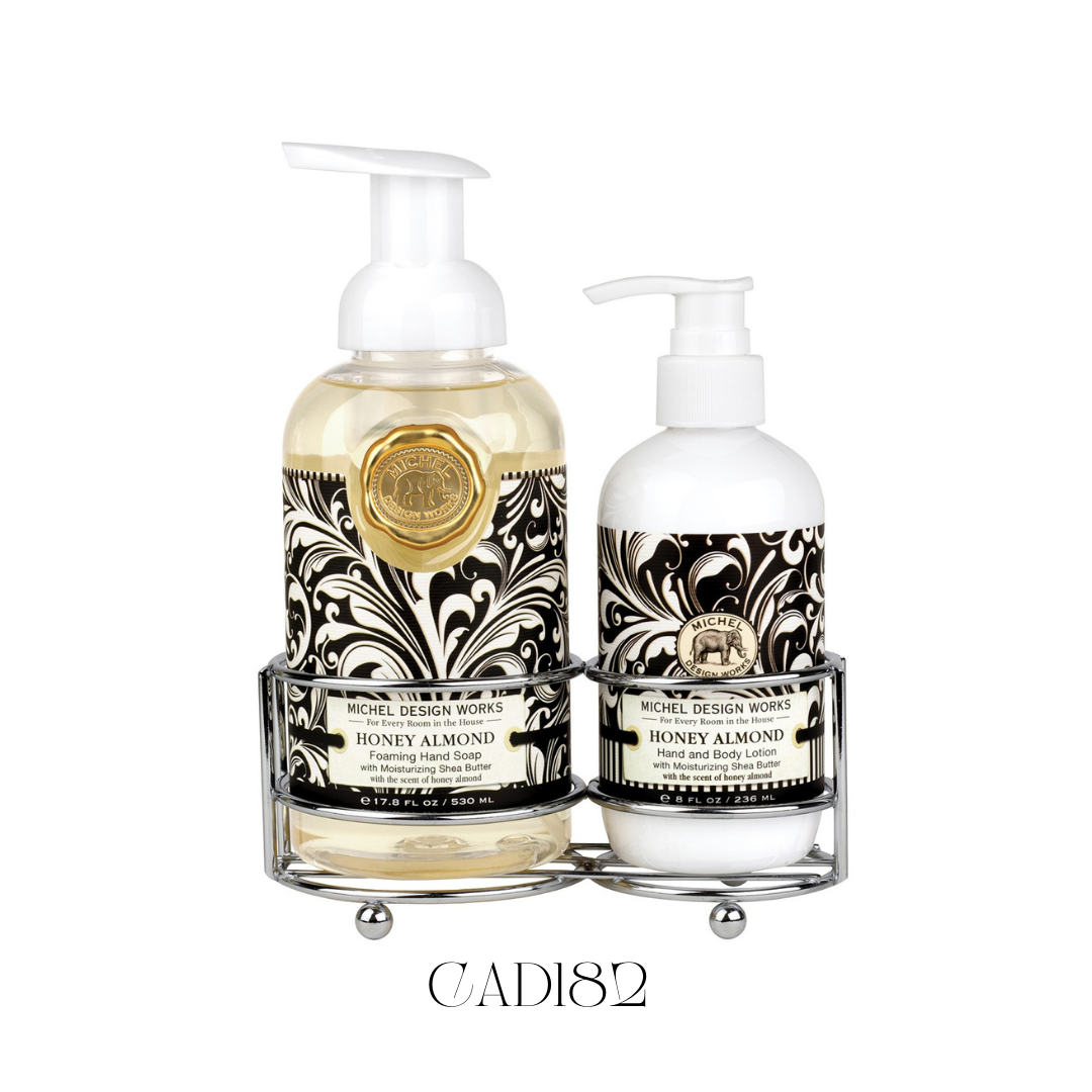 Hand Care Caddy Honey Almond featuring a foaming hand soap and a rich hand and body lotion, both with notes of toasted almonds, sweet cherries, smooth vanilla, and a touch of honey. Set in a stylish silver-toned caddy with a black and white design, perfect for adding a classic and elegant touch to kitchen counters or guest bathrooms