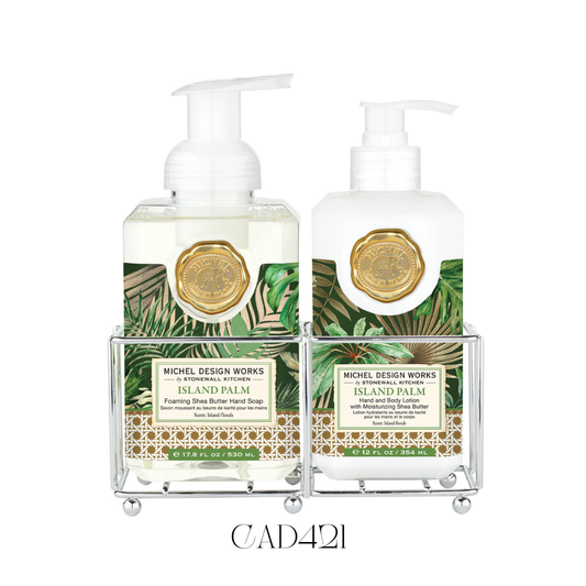 Hand Care Caddy (New Shape) Island Palm featuring a foaming hand soap and a rich hand and body lotion with notes of lush flowers, sweet fruits, and tuberose. Set in a stylish silver-toned caddy, perfect for adding a tropical touch to kitchen counters or guest bathrooms