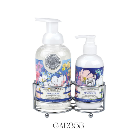 Hand Care Caddy Magnolia featuring a foaming hand soap and a rich hand lotion, both with a gentle, sweet magnolia scent blended with other floral notes. Set in a stylish silver-tone caddy with a vibrant, painterly magnolia design, perfect for adding a touch of elegance to bathroom or kitchen décor