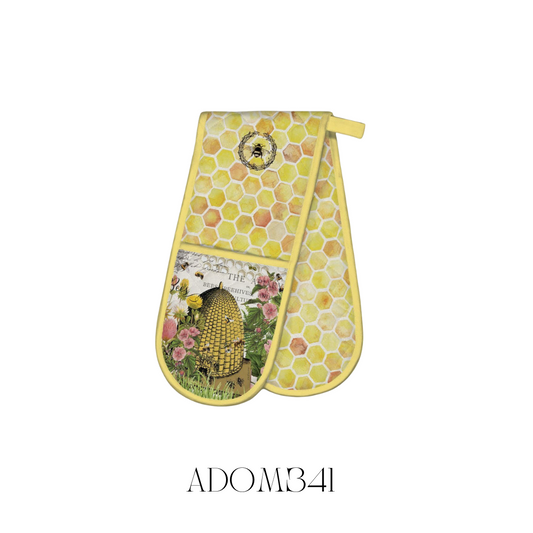 Honey and Clover Double Oven Mitt laid flat, made of 100% cotton with a cotton/poly fill for extra thickness and protection from hot dishes. The oven mitt features a charming honey and clover design and measures approximately 85 x 27.75 cm