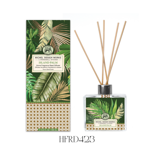 Island Palm Reed Diffuser set featuring a chic glass decanter with beautifully printed artwork, designed to fill any room with a tropical fragrance. The scent includes lush island flowers, sweet tropical fruits, and tuberose highlights. The set comes with eight reeds and 100ml of fragrance oil, perfect for kitchens or bathroom