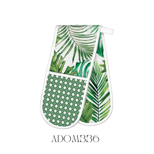 Palm Breeze Double Oven Mitt in use, showcasing its extra-thick padding and durable cotton construction for maximum heat resistance. The tropical palm pattern adds a lively touch to any kitchen décor while providing essential protection from hot cookware