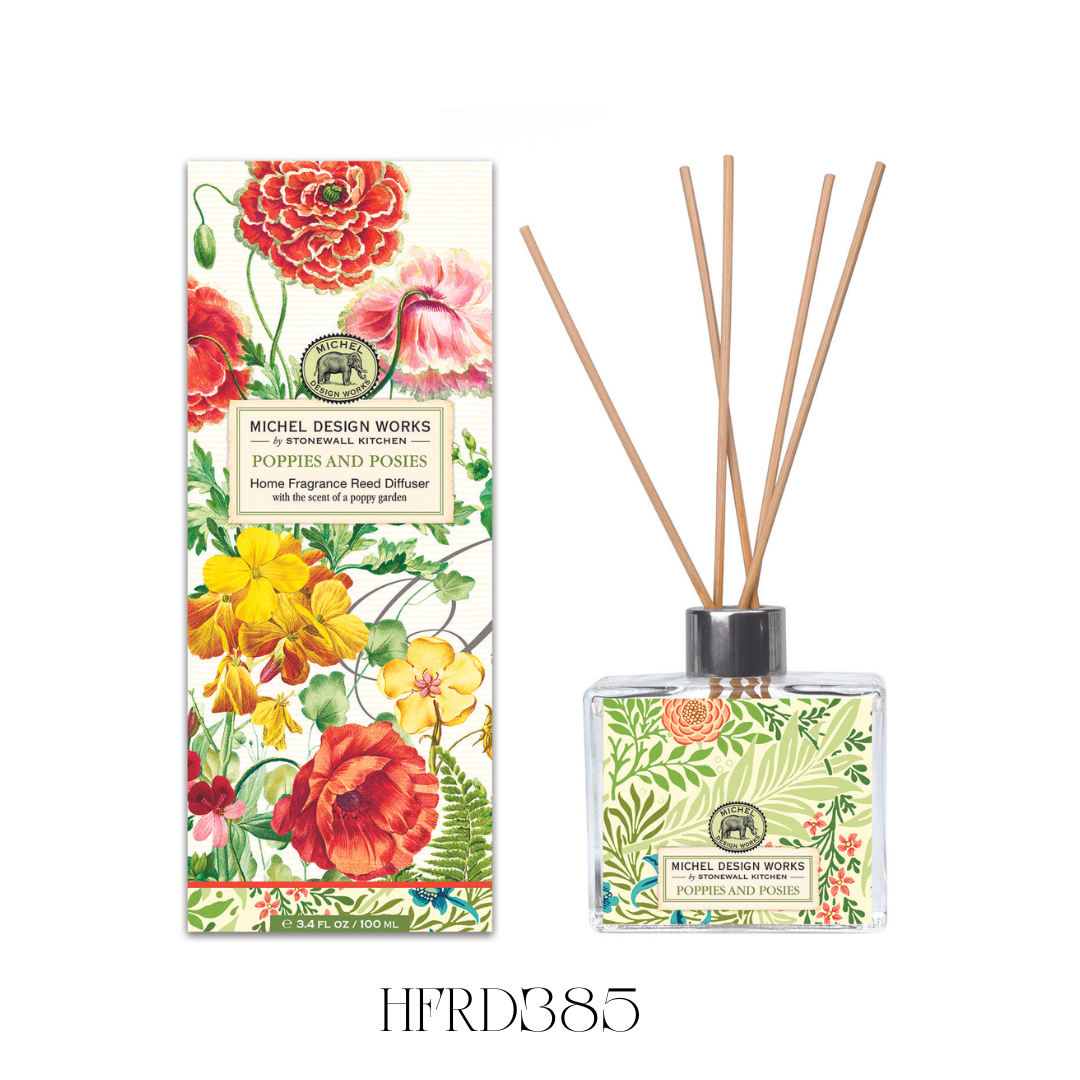 Poppies and Posies Reed Diffuser displayed on a bathroom counter, showcasing the stylish glass decanter with vibrant floral artwork and eight reeds. The diffuser releases a fresh blend of floral scents, including poppy, jasmine, violet, and fruity notes, adding a charming touch to any room