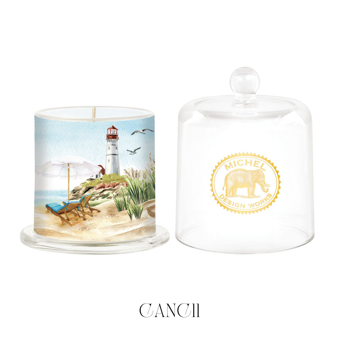 Seaside Cloche Candle with the glass cloche removed, showcasing the elegantly designed candle with a soy blend wax. The candle emits a refreshing scent reminiscent of the seaside, perfect for adding a coastal feel to your home décor.