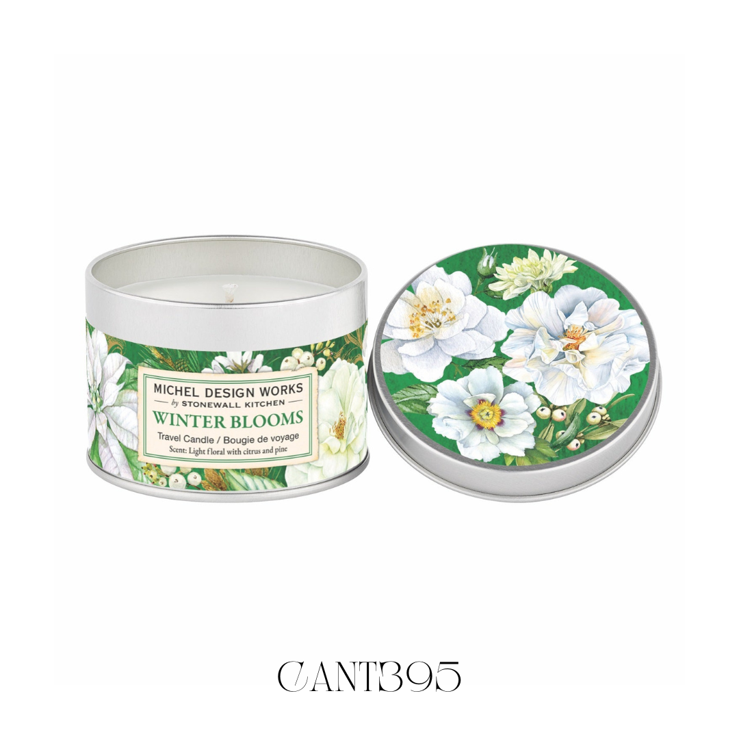 Lit Winter Blooms Large Travel Candle in a portable tin, showcasing its clean-burning soy wax. The candle emits a delicate scent of magnolia, complemented by hints of citrus, evergreen, and spice, ideal for creating a cosy and inviting atmosphere in any space.