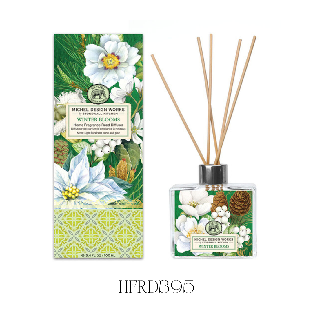 Winter Blooms Reed Diffuser displayed in a kitchen, showcasing the elegant glass decanter with detailed artwork and eight reeds. The diffuser releases a fresh, festive blend of light florals, citrus, and pine, ideal for creating a lively winter atmosphere in any room.