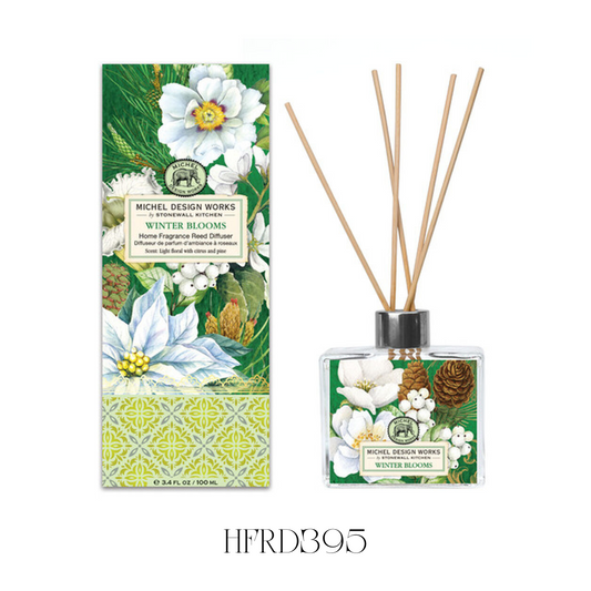 Winter Blooms Reed Diffuser displayed in a kitchen, showcasing the elegant glass decanter with detailed artwork and eight reeds. The diffuser releases a fresh, festive blend of light florals, citrus, and pine, ideal for creating a lively winter atmosphere in any room.